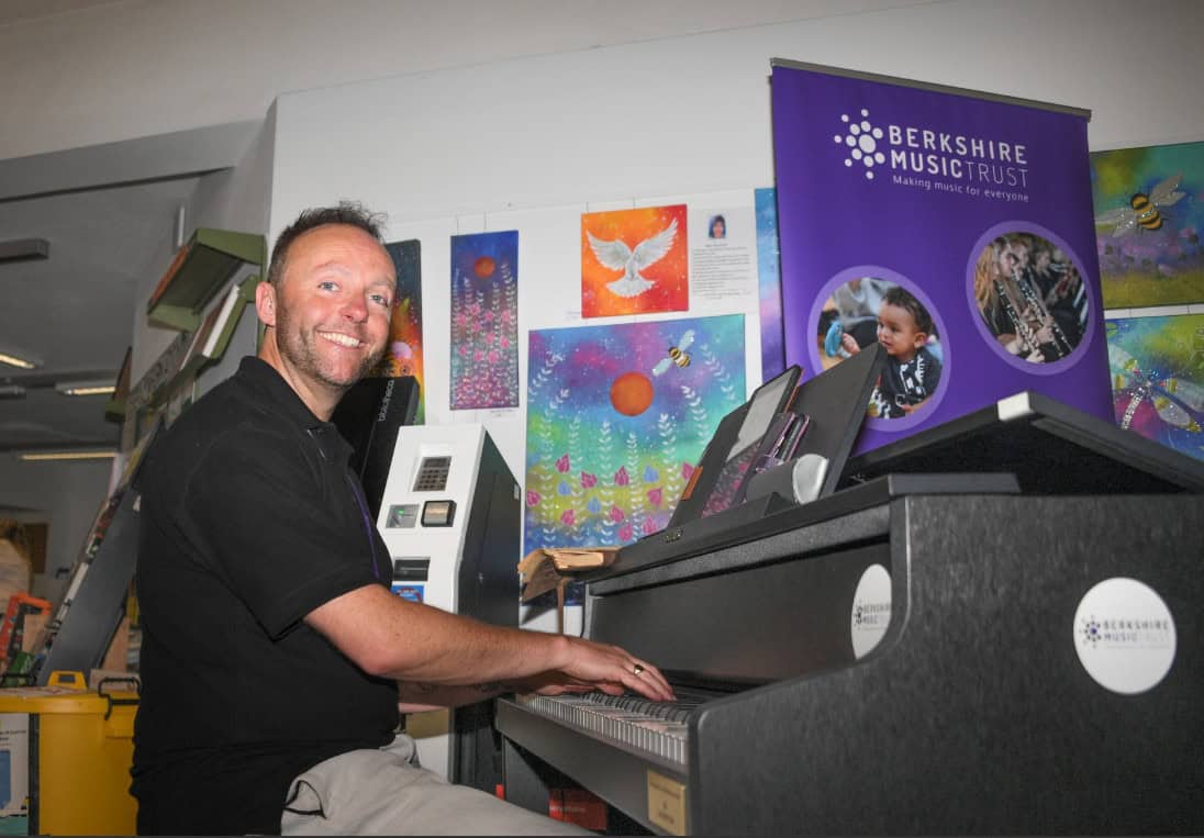 Jamie Read, Partnership and Inclusion Manager at Berkshire Music Trust, playing piano at Lower Earley Library